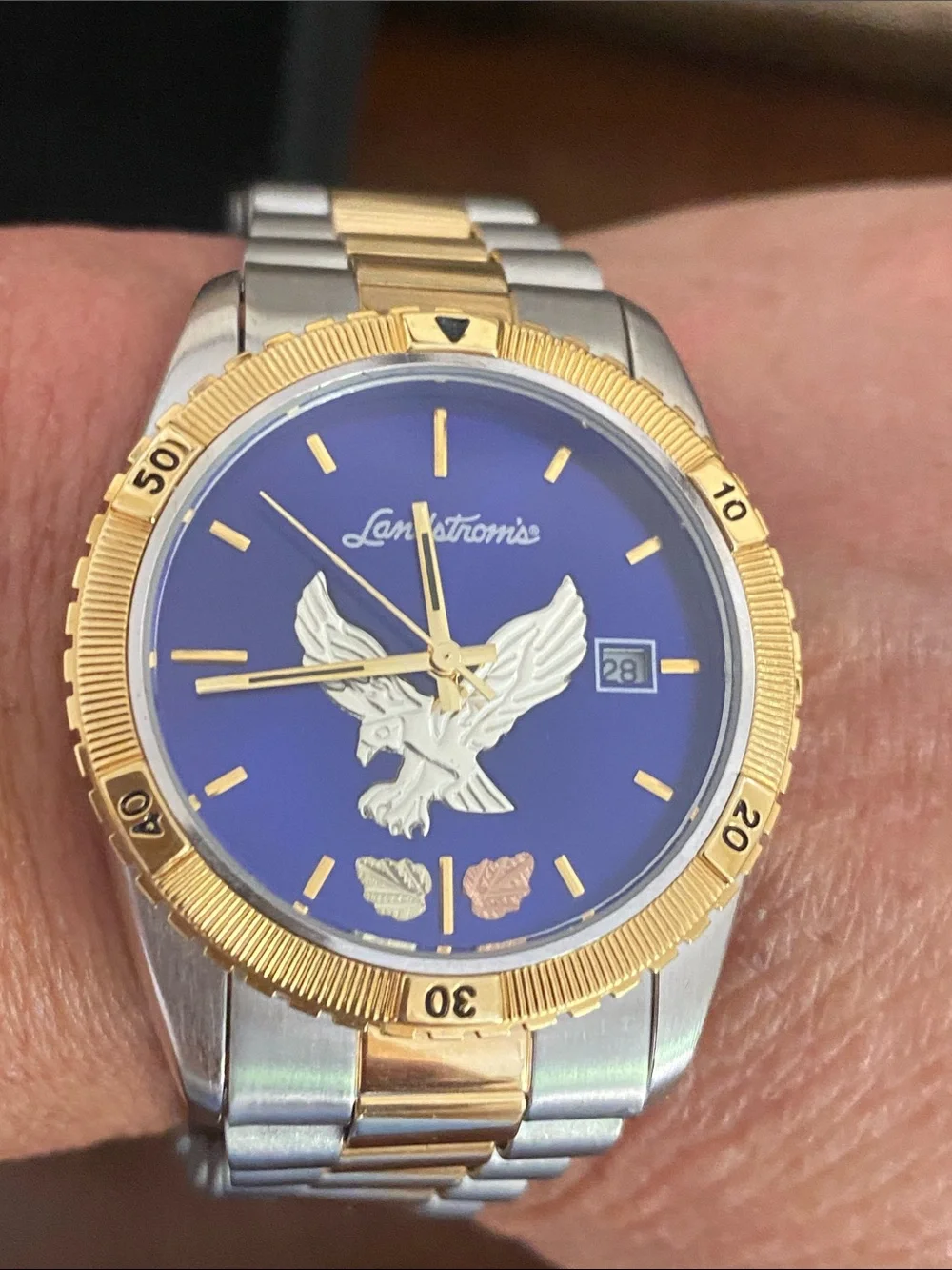 Landstrom’s Black Gold Watch with Blue Dial and Eagle Motif two tone band